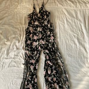 Size medium black floral romper with tied back slits on both sides